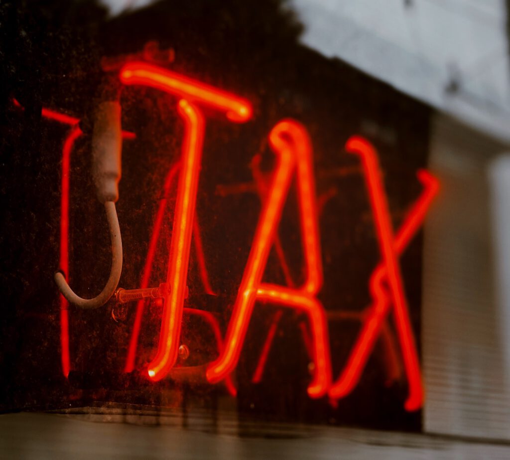 red neon tax sign