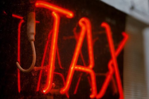 red neon tax sign